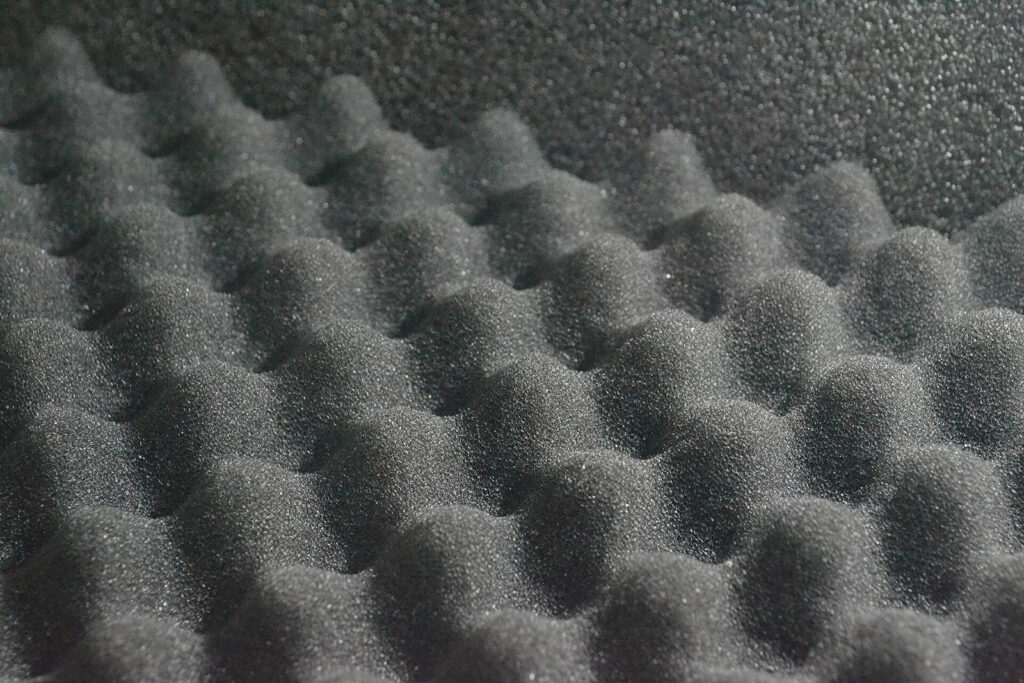 Acoustic Absorption Porous acoustic foam illustrating the internal surface structure responsible for viscous and thermal energy dissipation.